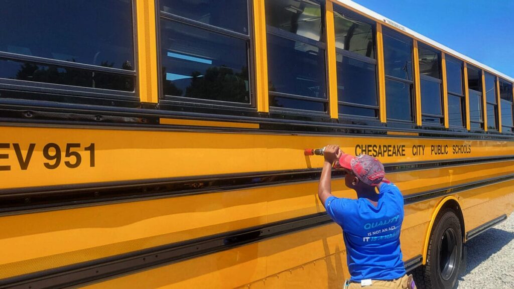 Technician installing BusPatrol cameras on a Chesapeake bus